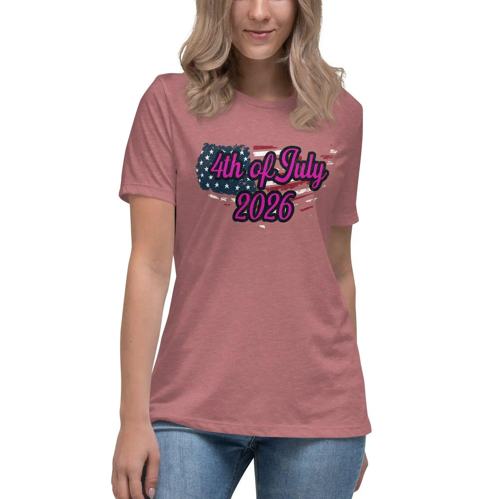 A woman wearing a heather mauve patriotic t-shirt with the American flag in the shape of America and the text "4th of July, 2026."