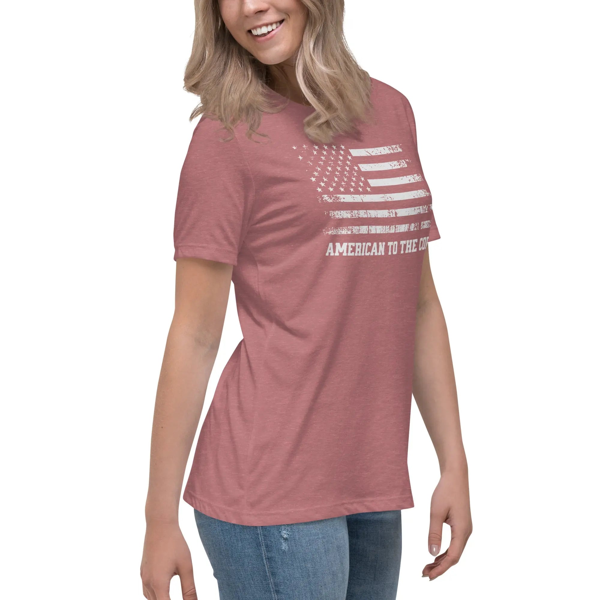 A woman wearing a patriotic heather mauve t-shirt with the American flag in black and white and "American to the core" text