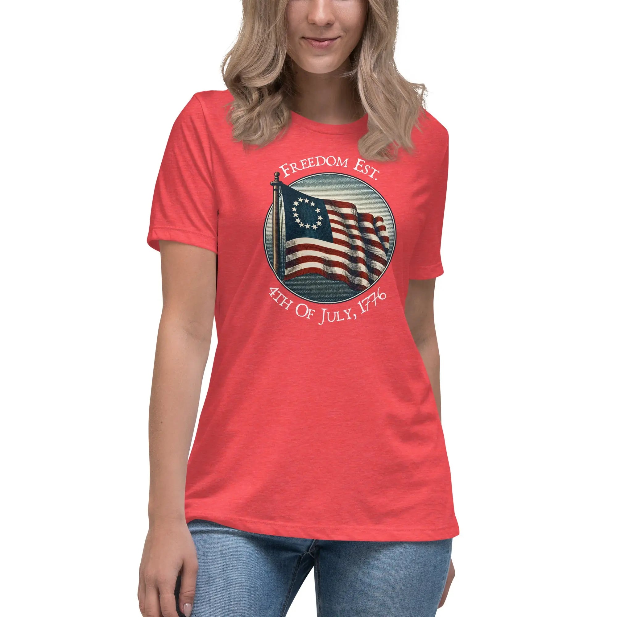 A woman wearing a heather red patriotic t-shirt with the American flag and the text "Freedom est. 4th of July, 1776."