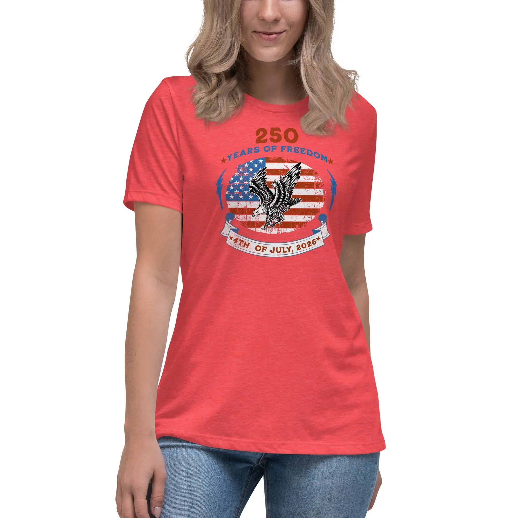 A woman wearing a red heather patriotic t-shirt with the American flag with a flying eagle over it and the text "250 years of freedom 4th of July, 2026."