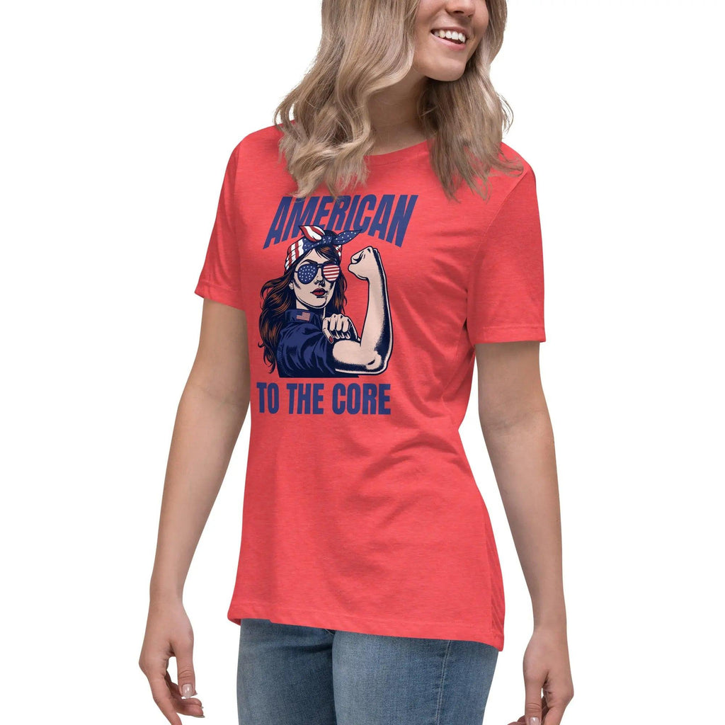 A woman wearing a heather red, patriotic t-shirt with a strong woman and "American To The Core" text.