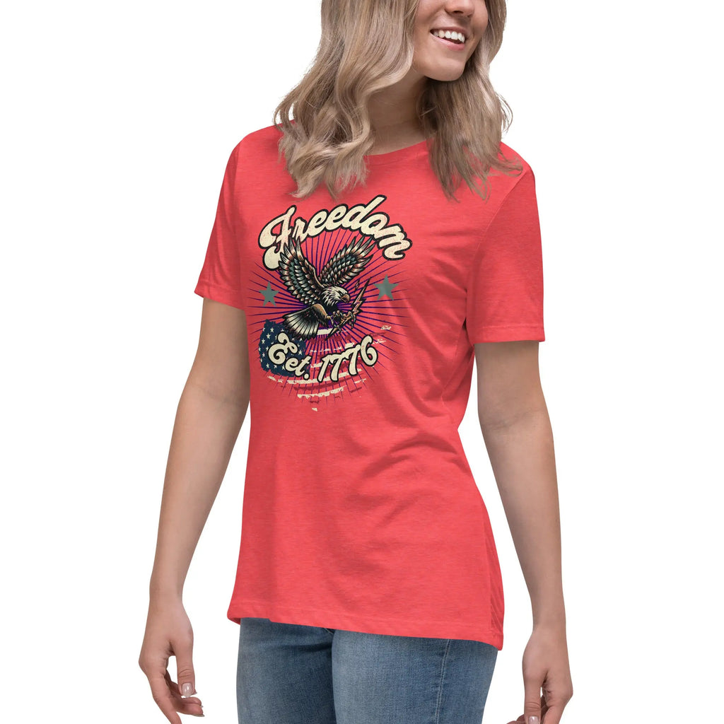 A woman wearing a heather red patriotic t-shirt with an eagle and "Freedom Est. 1776" text.