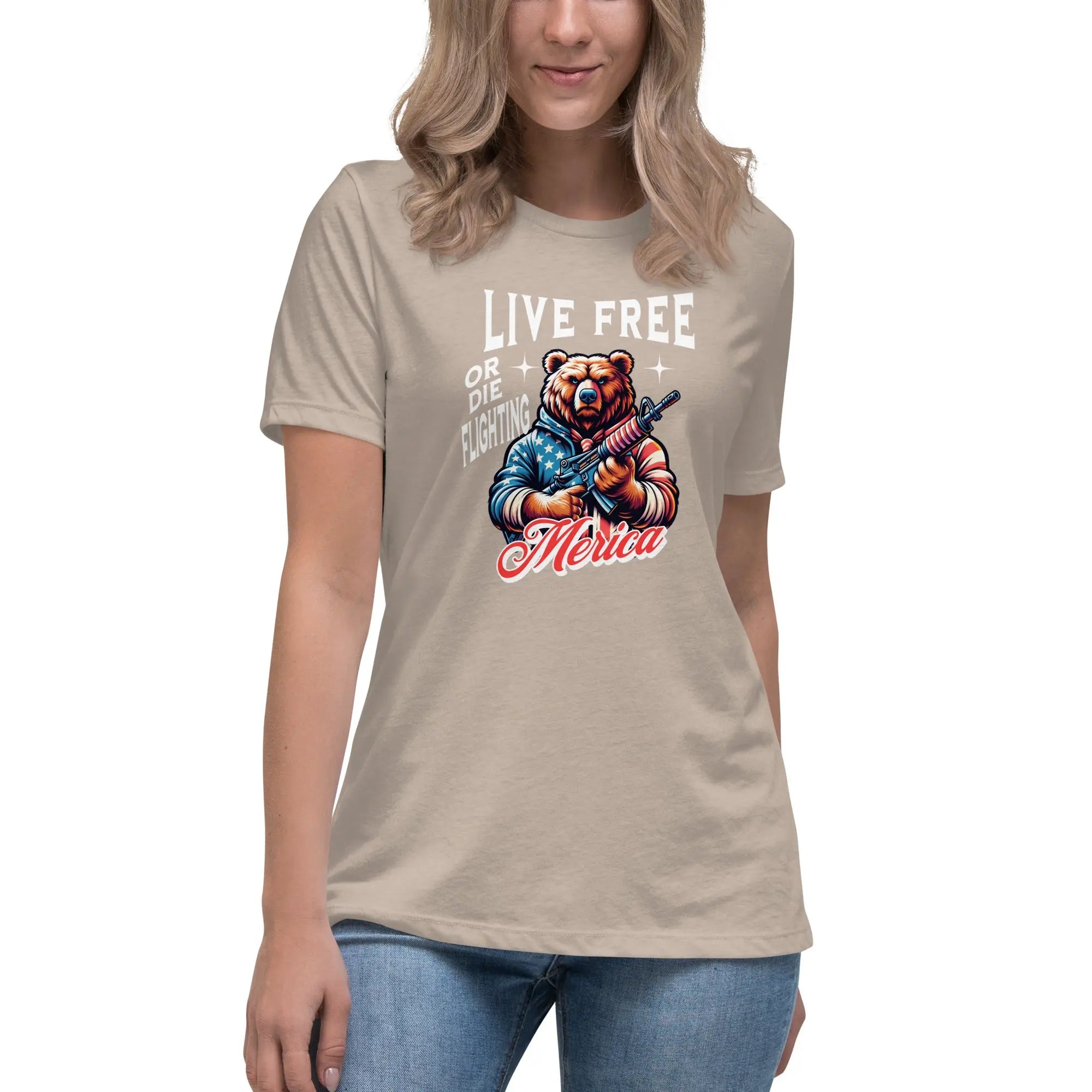 A woman wearing a heather stone patriotic t-shirt with a bear holding a gun and "Live Free or Die Fighting" text.