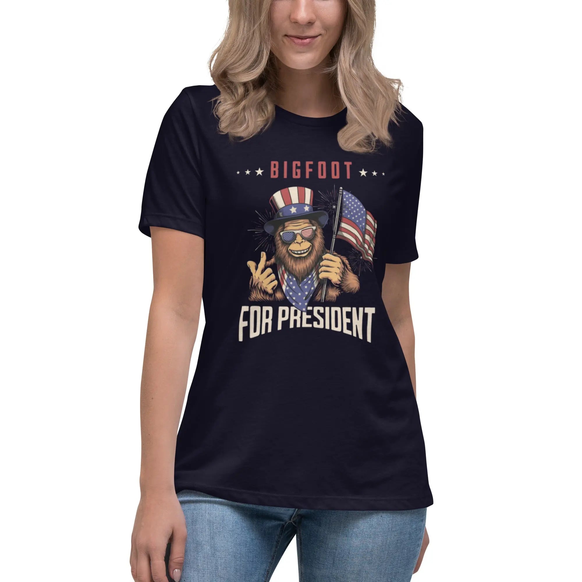 A woman wearing a navy patriotic t-shirt with Bigfoot and "Bigfoot For President" text.