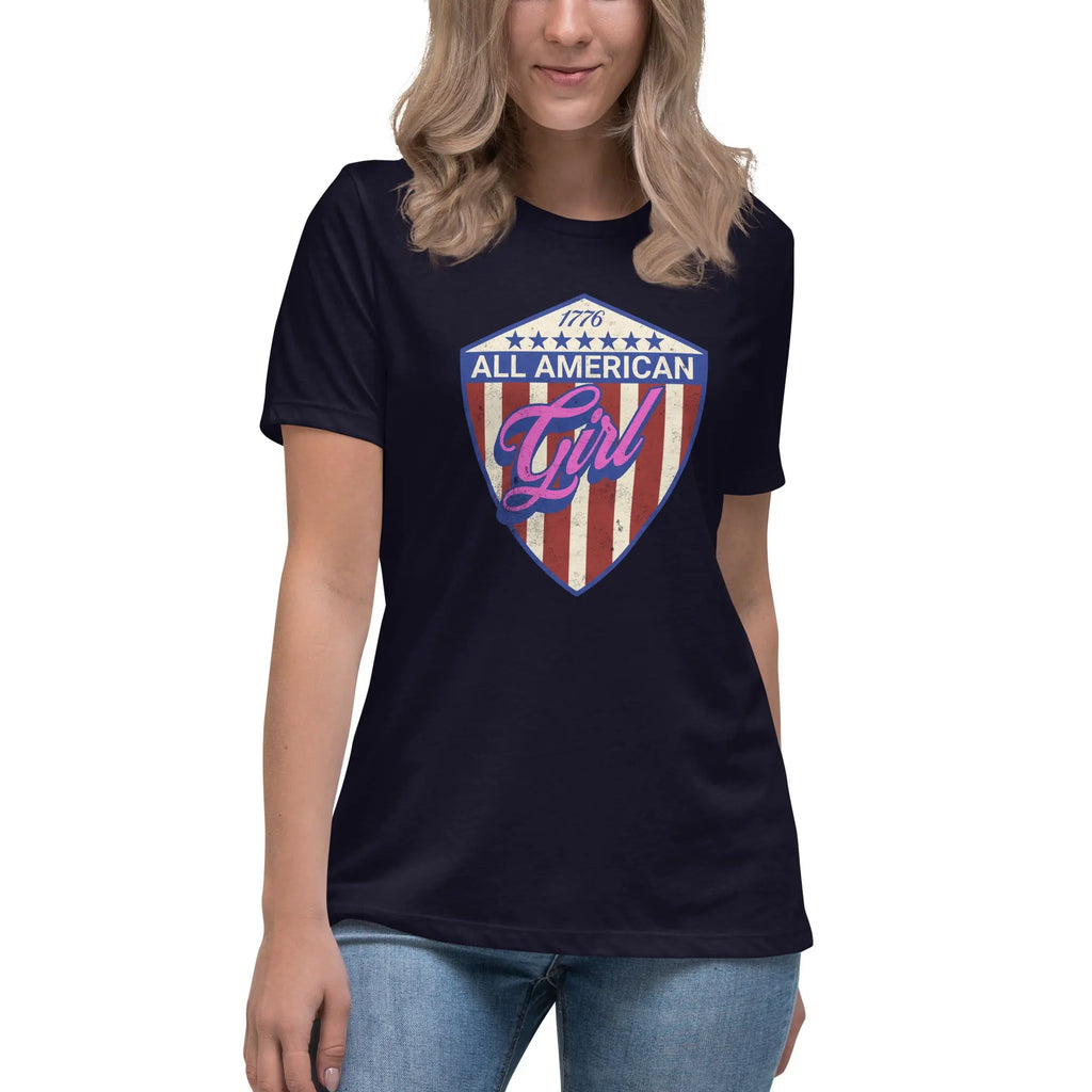 A woman wearing a navy patriotic t-shirt with "All-American Girl" text. over a red, white, and blue shield.