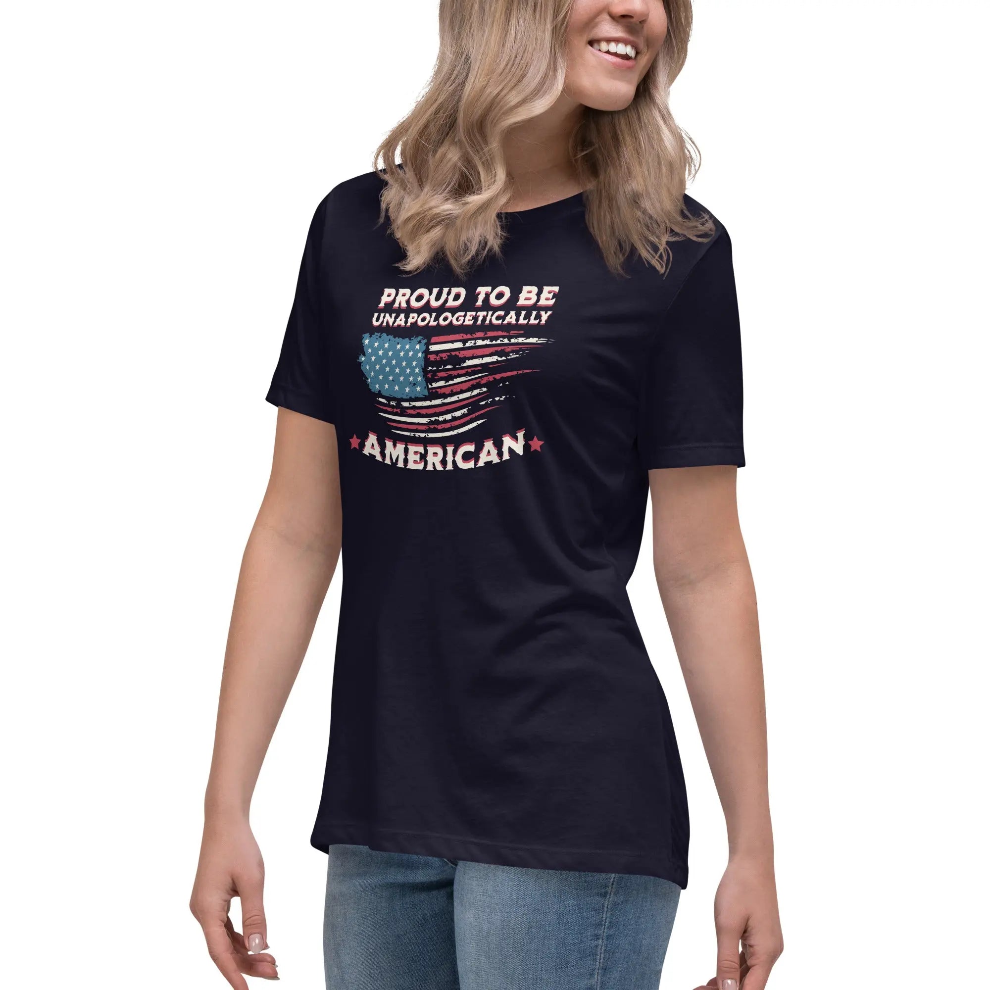 A woman wearing a navy patriotic t-shirt with the American flag and "Proud To Be Unapologetically American" text.