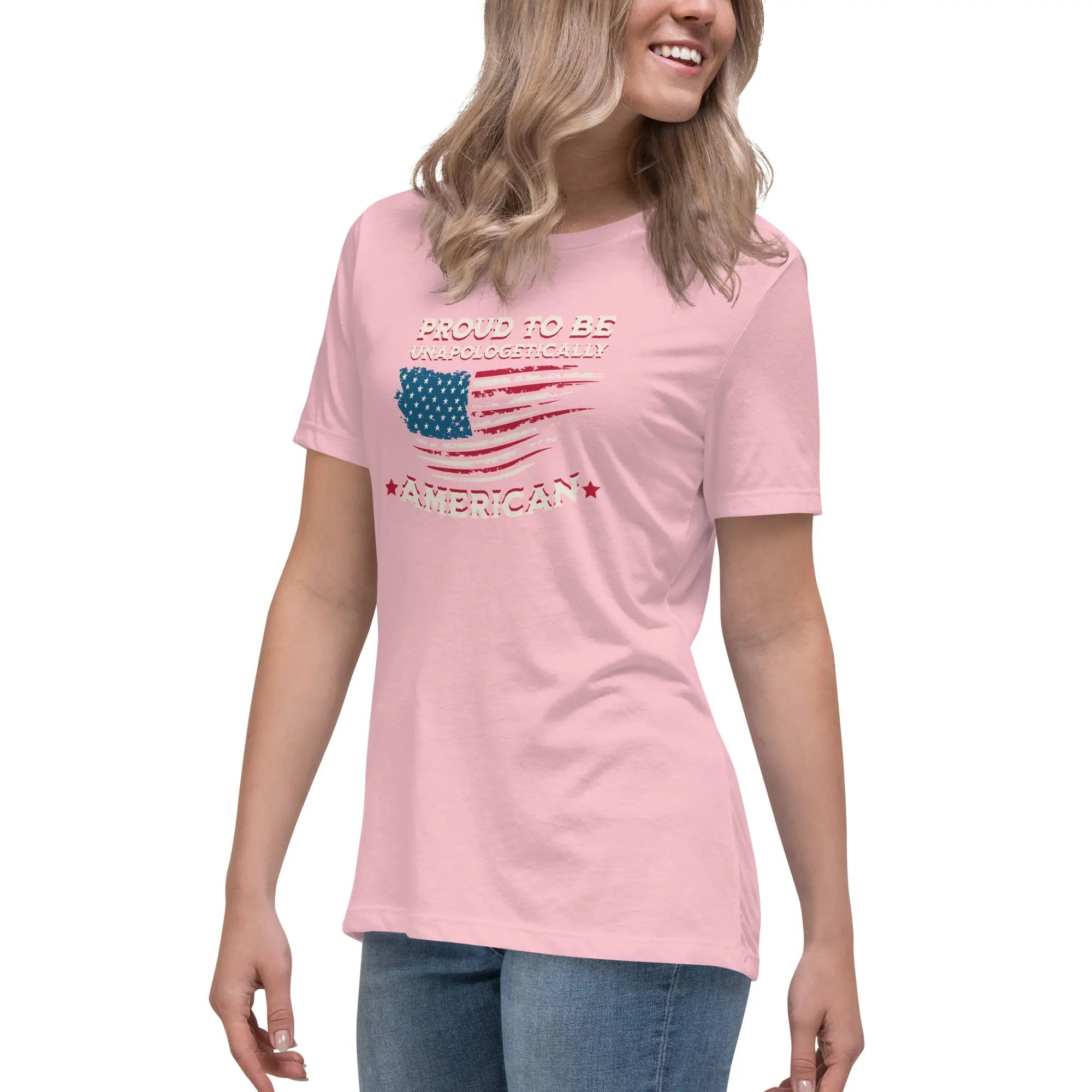 A woman wearing a pink patriotic t-shirt with the American flag and "Proud To Be Unapologetically American" text.
