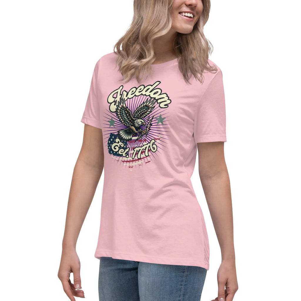 A woman wearing a pink patriotic t-shirt with an eagle and "Freedom Est. 1776" text.