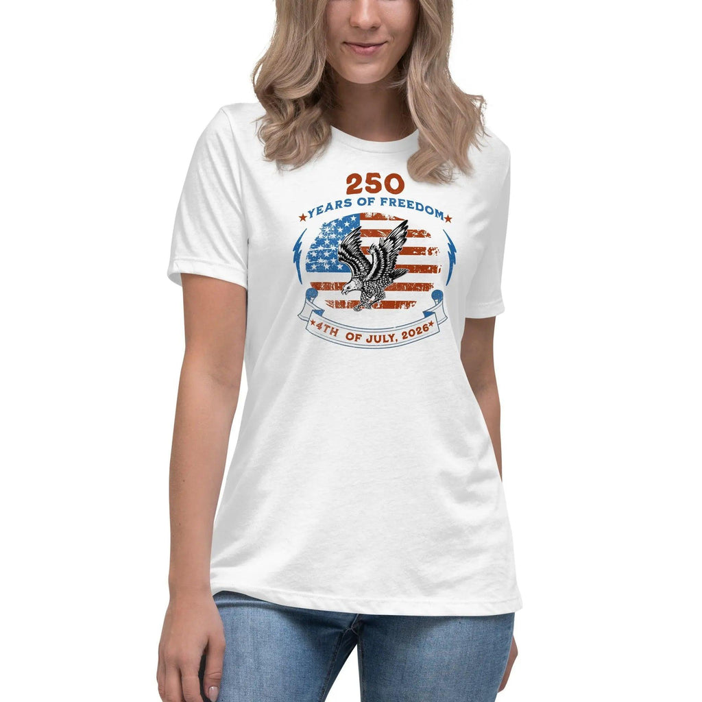 A woman wearing a white patriotic t-shirt with the American flag with a flying eagle over it and the text "250 years of freedom 4th of July, 2026."