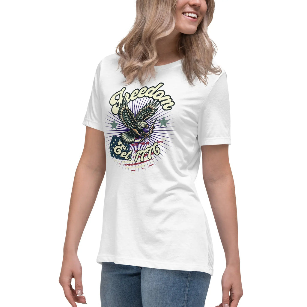 A woman wearing a white patriotic t-shirt with an eagle and "Freedom Est. 1776" text.